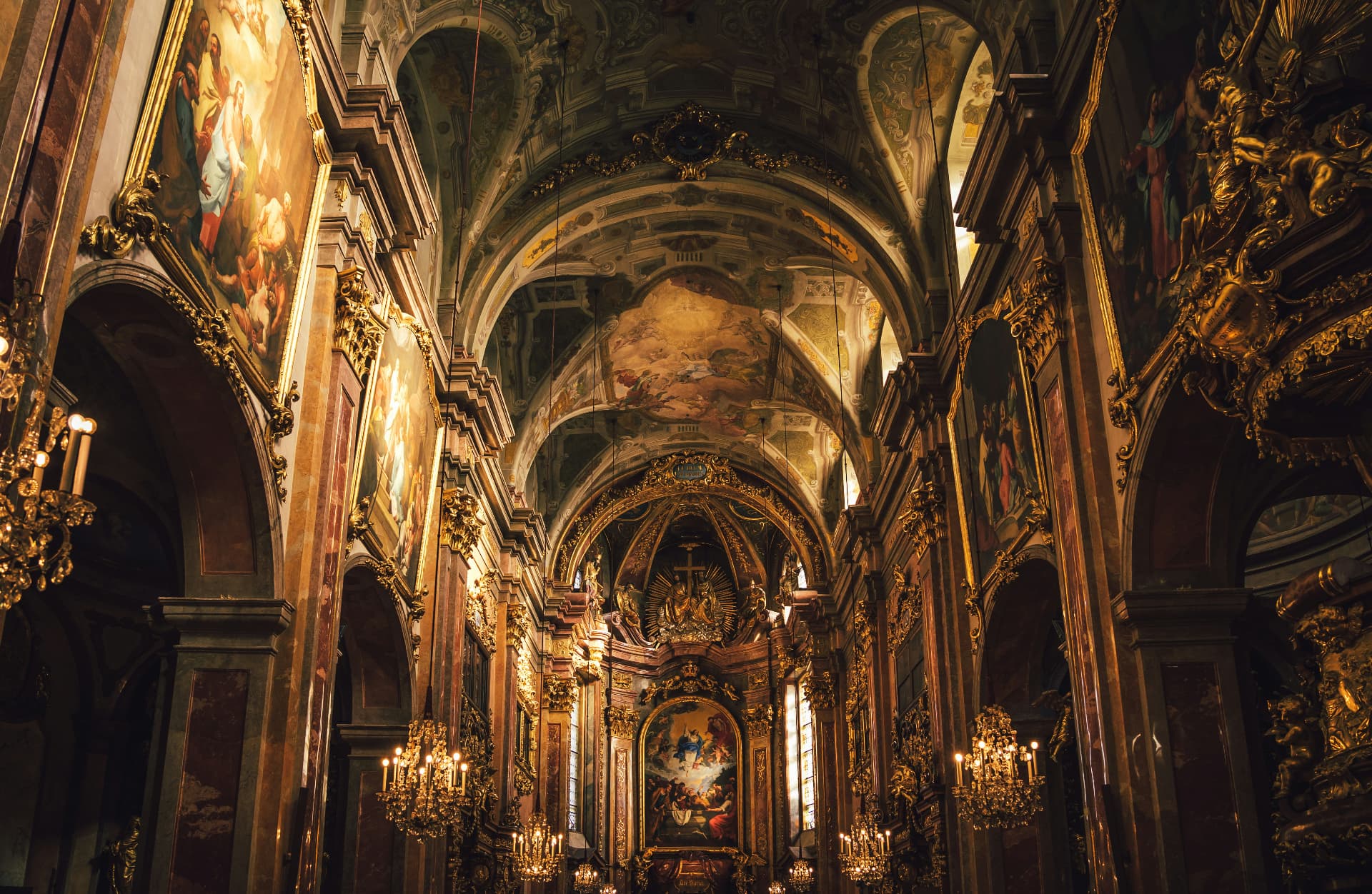 Ornate Catholic church interior with sacred art and chandeliers
